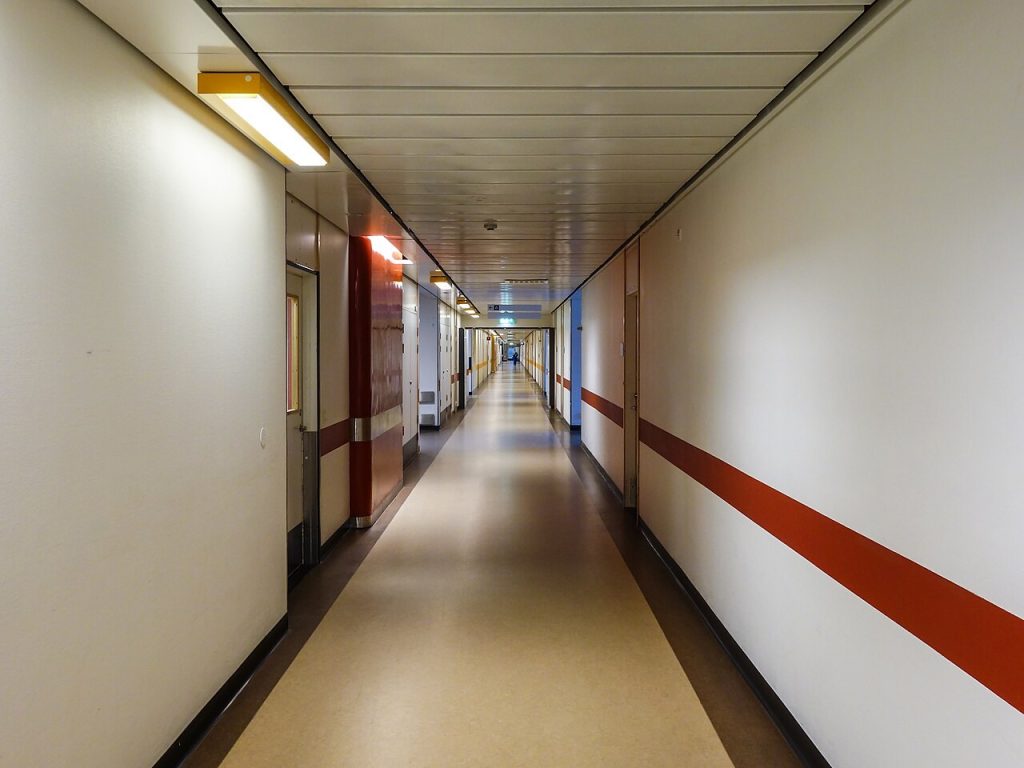 Mother of Six Sues After Hysterectomy Complications: The Case and Its Safety Questions Hospital corridor with medical lighting
